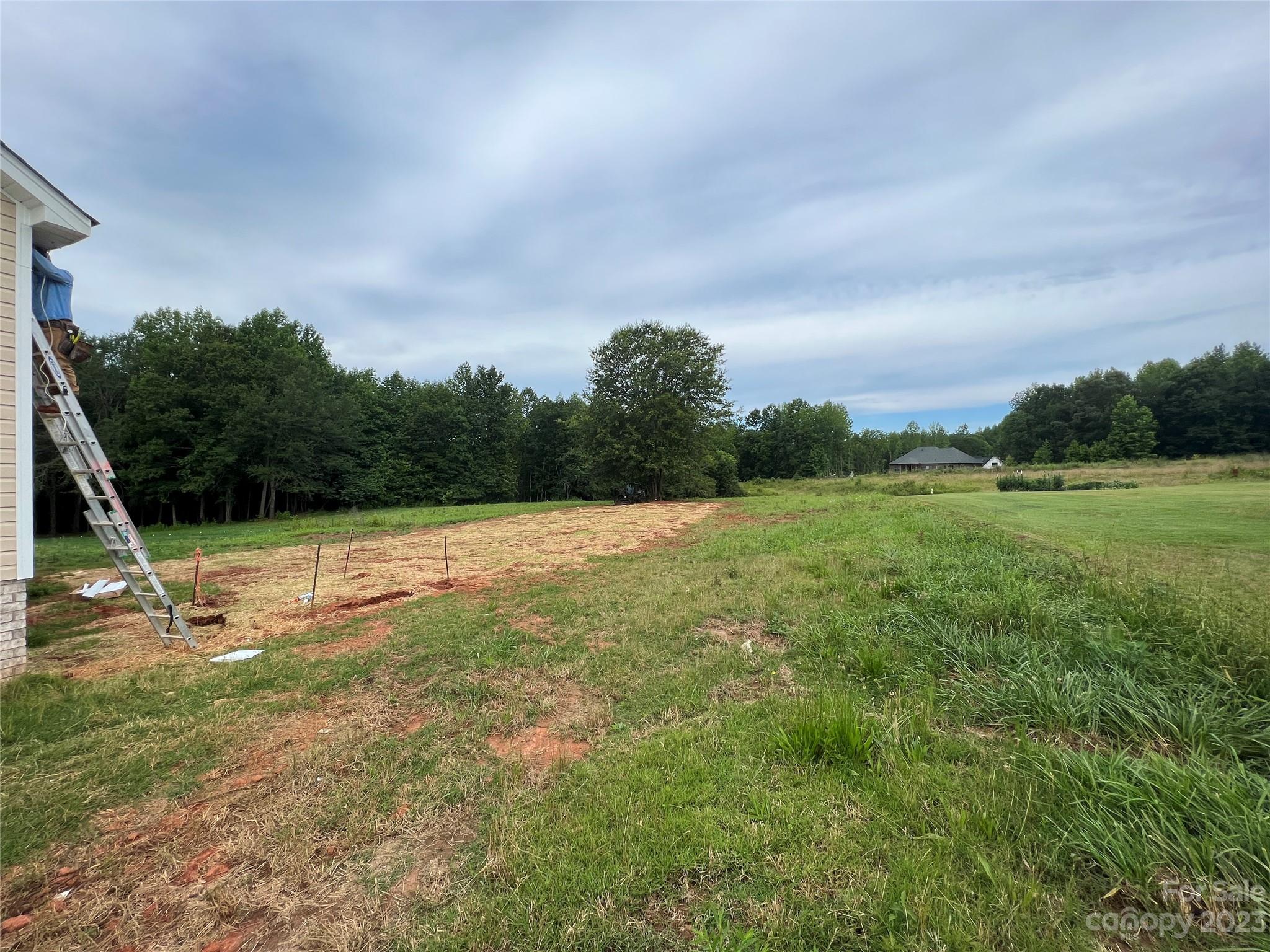 8018 Smooth Stone Court, Unit 71 Clover, SC 29710 - Photo 18 of 21 a view of a green field with wooden fence