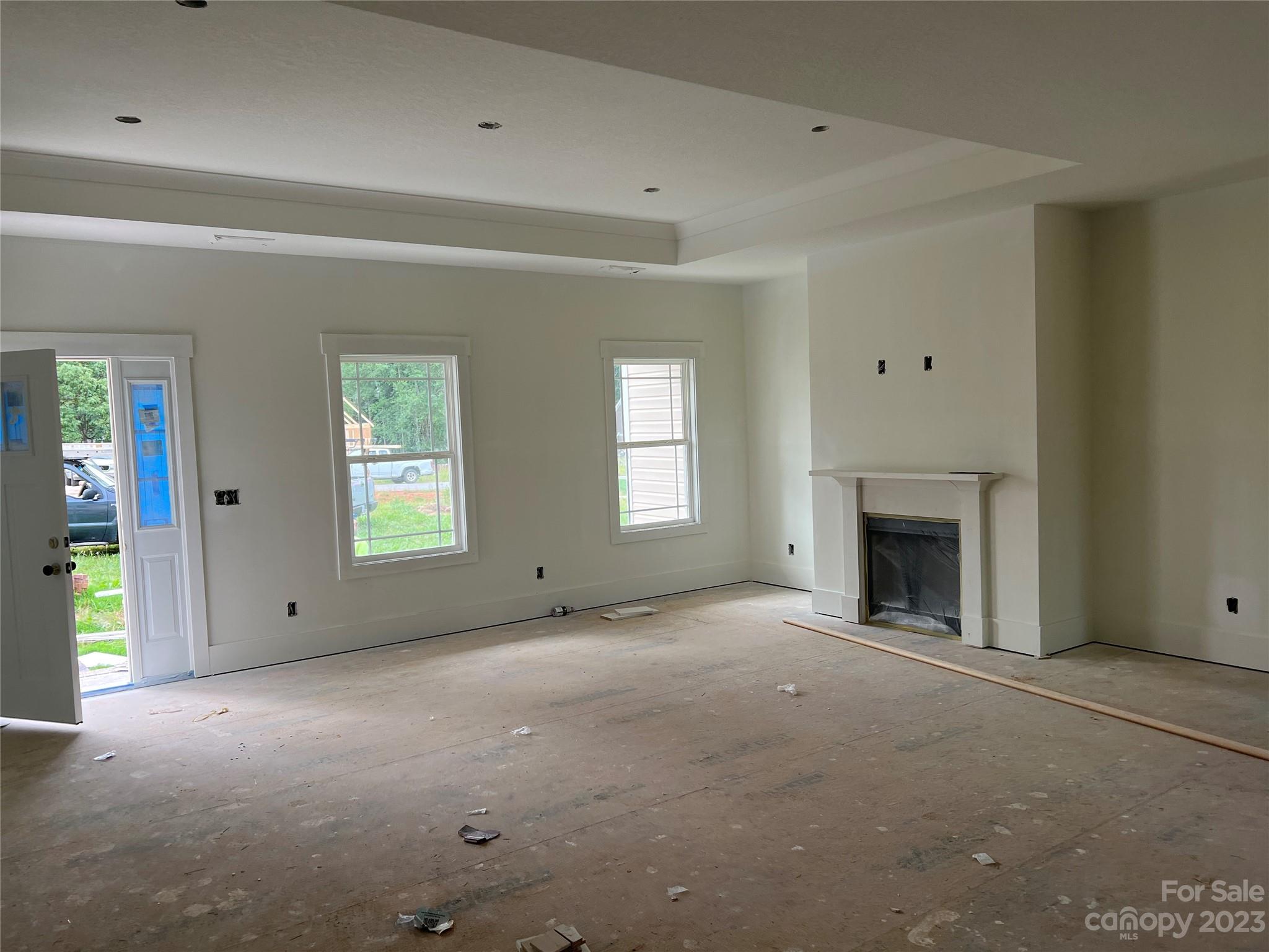 8018 Smooth Stone Court, Unit 71 Clover, SC 29710 - Photo 2 of 21 an empty room with a fireplace and windows