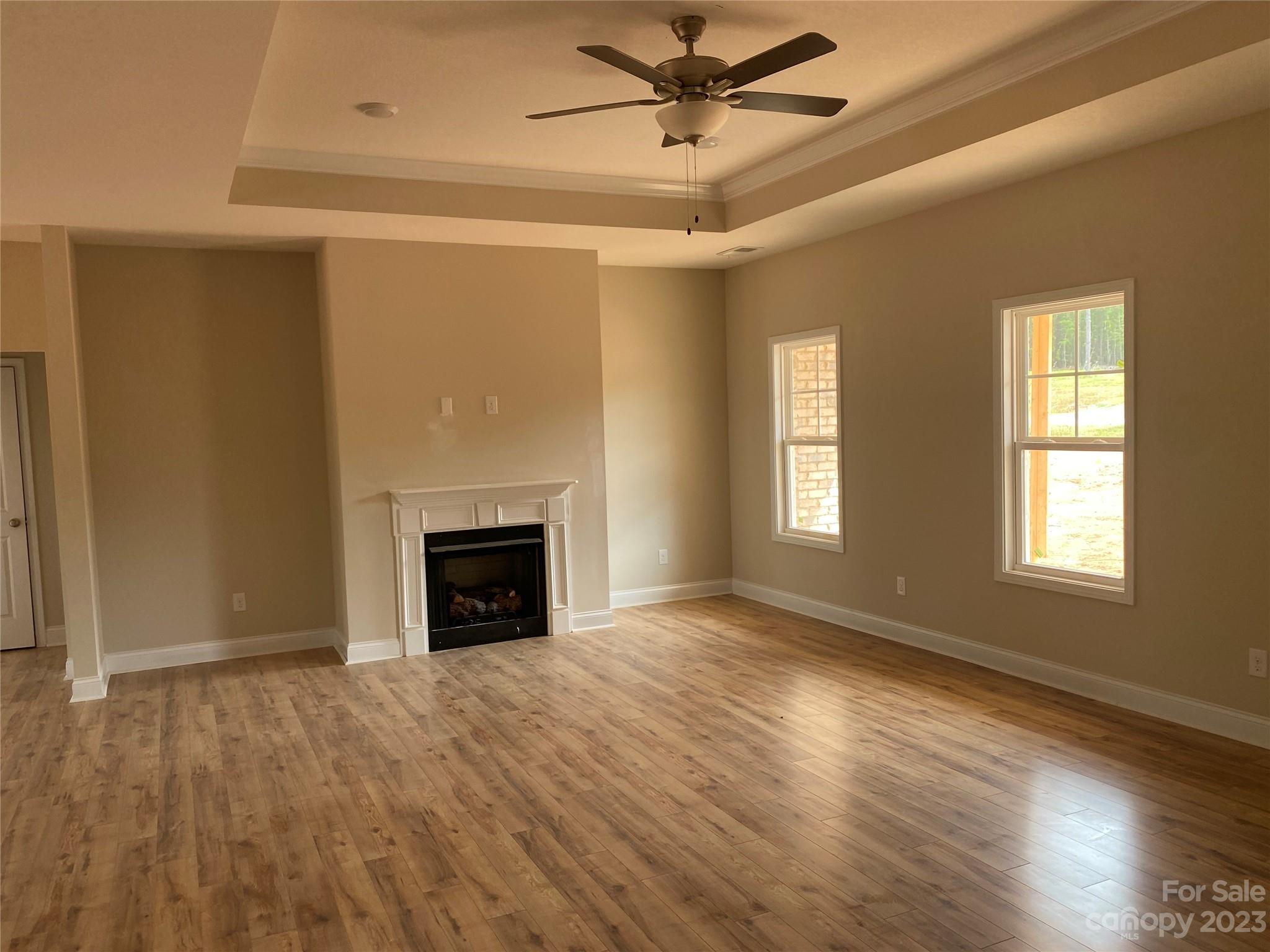 8018 Smooth Stone Court, Unit 71 Clover, SC 29710 - Photo 21 of 21 a view of an empty room with wooden floor fireplace and a window