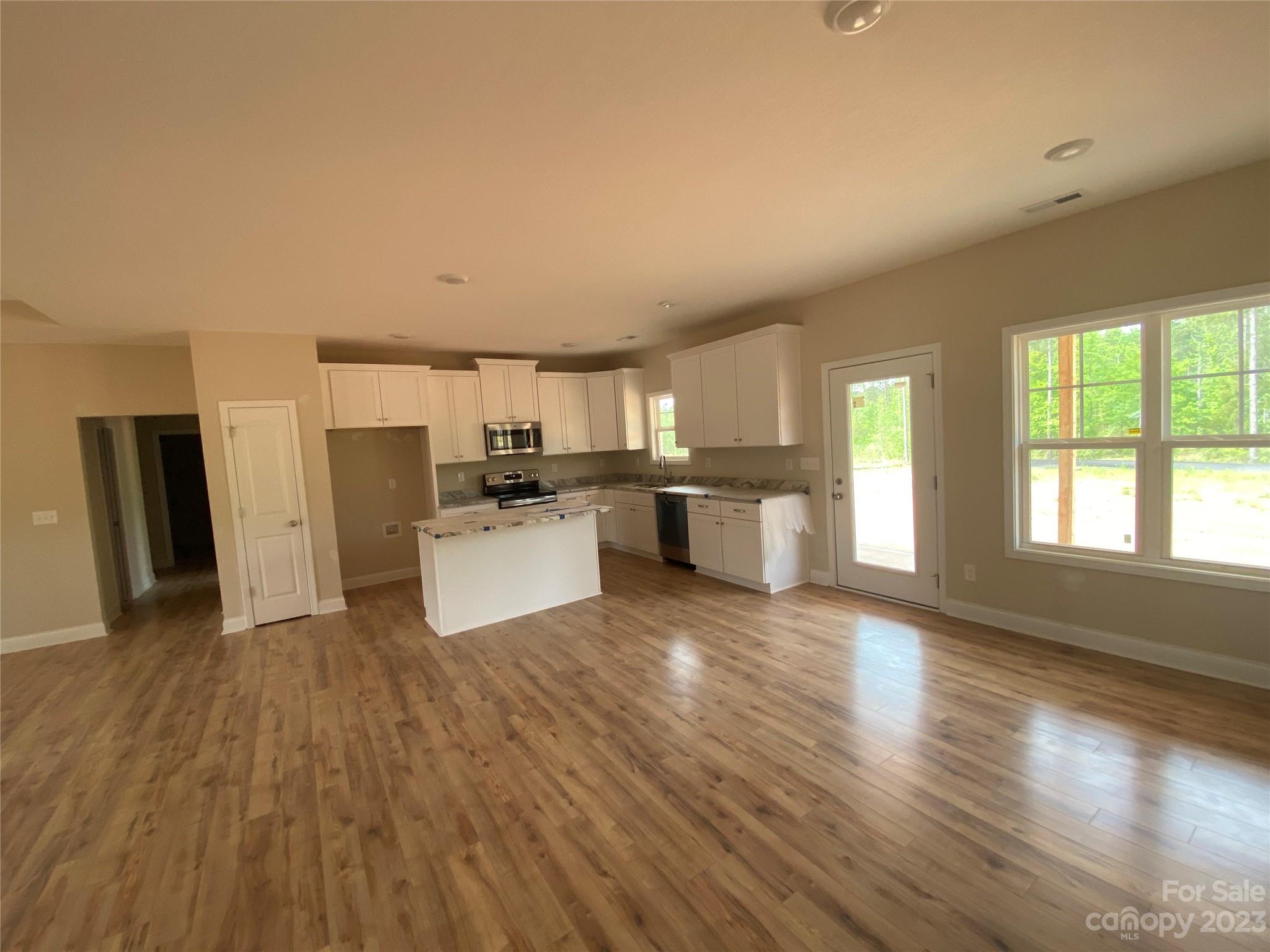8018 Smooth Stone Court, Unit 71 Clover, SC 29710 - Photo 4 of 21 a kitchen with a refrigerator and a stove top oven