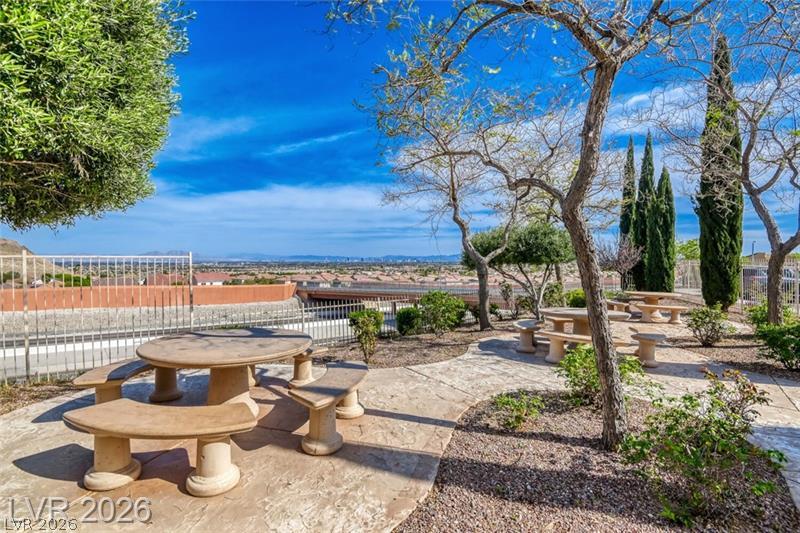 10550 West Alexander Road, Unit 2148 Las Vegas, NV 89129 - Photo 36 of 41 A tranquil outdoor gathering spot features built-in picnic tables, offering scenic views for relaxed enjoyment.