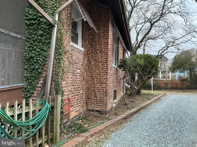 a backyard of a house with outdoor seating