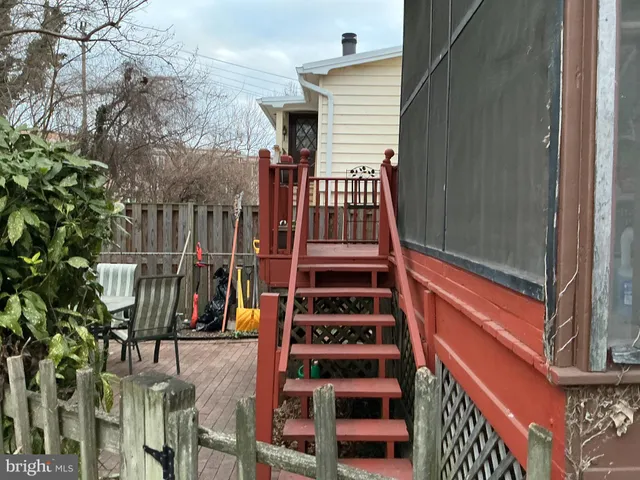 a view of backyard with deck and outdoor seating