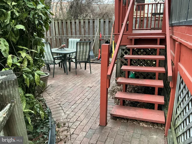 a balcony with table and chairs