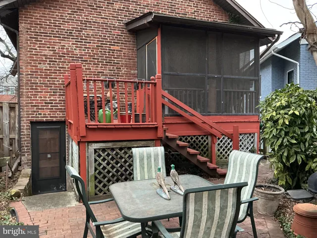 a view of a chairs and table in the balcony