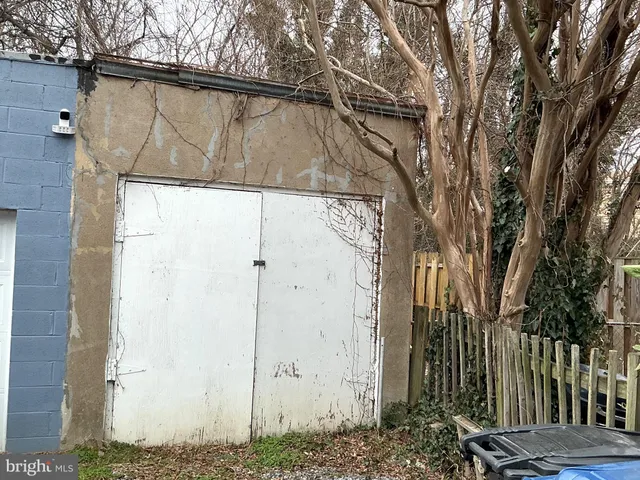 a front view of a house with a tree