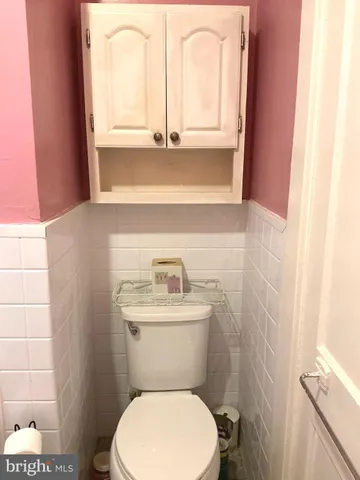a bathroom with a toilet a sink and a window