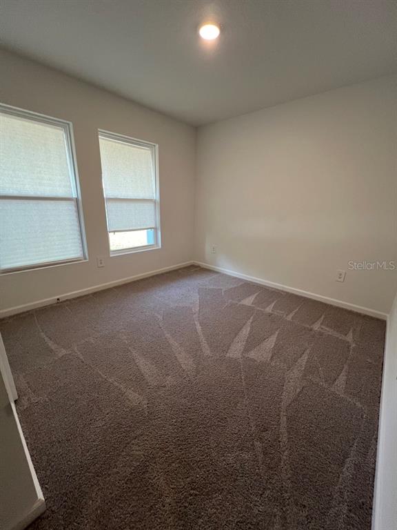 9131 Swiss Road Spring Hill, FL 34606 - Photo 7 of 16 an empty room with windows