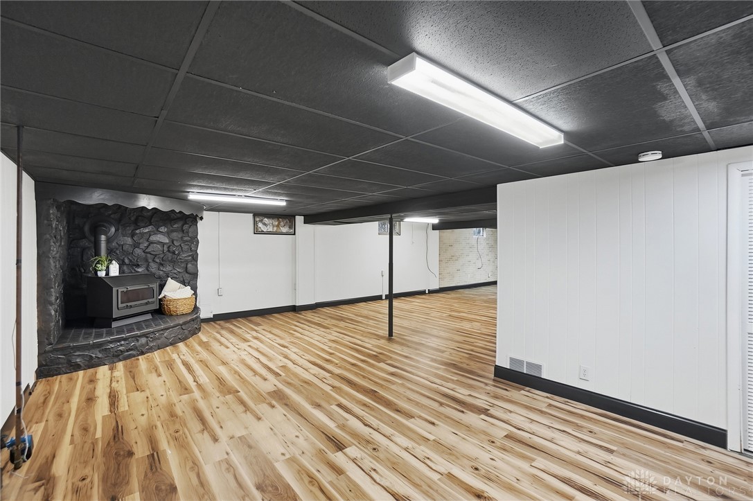 1628 Yorkshire Court Springfield, OH 45503 - Photo 27 of 47 This spacious basement features durable wood flooring, offering versatility for various activities and future customization.