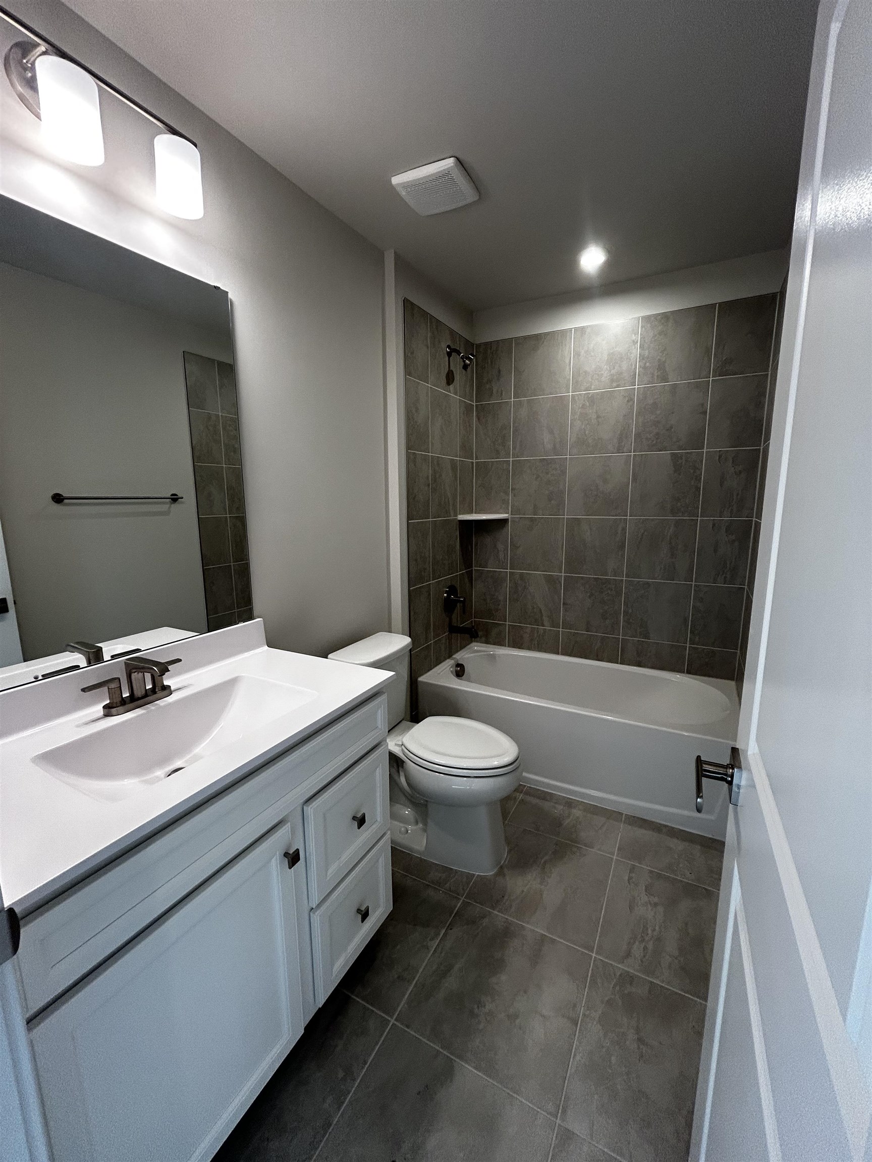 1301 Pleasant View Drive, Unit A North Myrtle Beach, SC 29582 - Photo 11 of 13 Bathroom with vanity, shower combination, and dark tile patterned floors