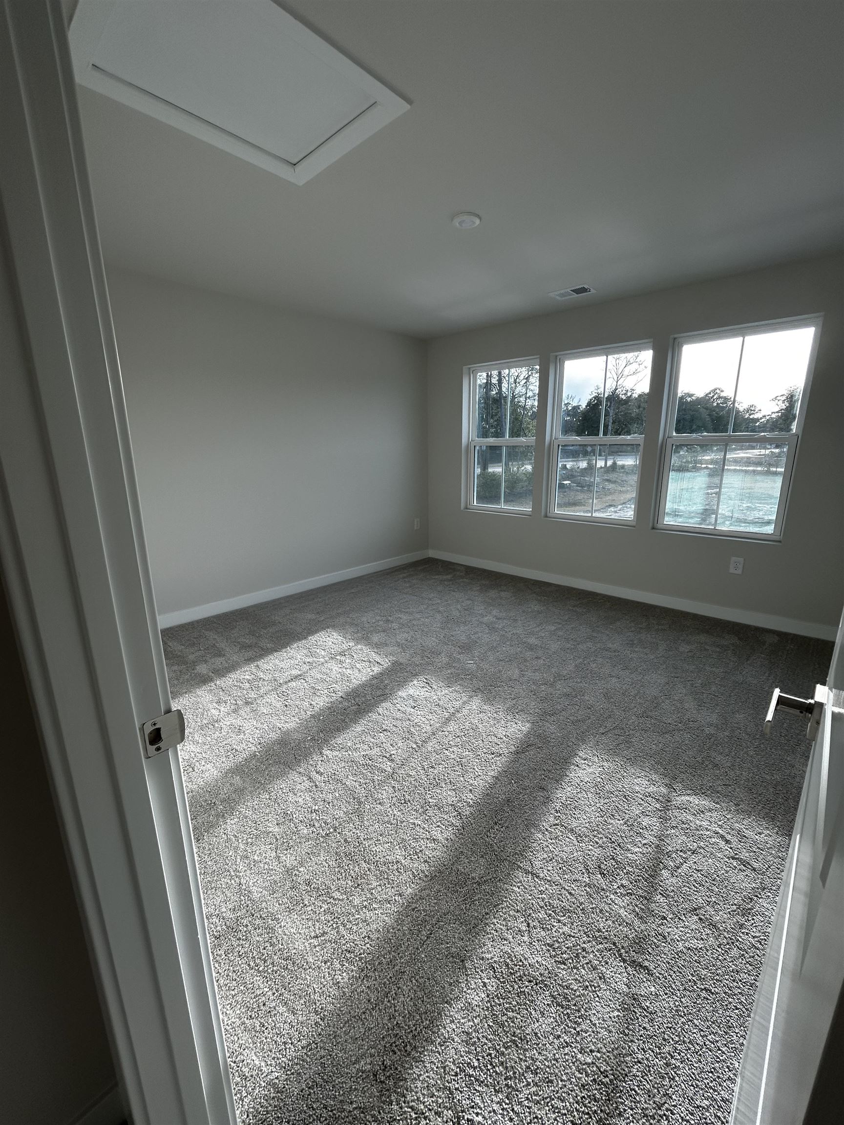 1301 Pleasant View Drive, Unit A North Myrtle Beach, SC 29582 - Photo 10 of 13 Unfurnished room featuring carpet flooring and attic access