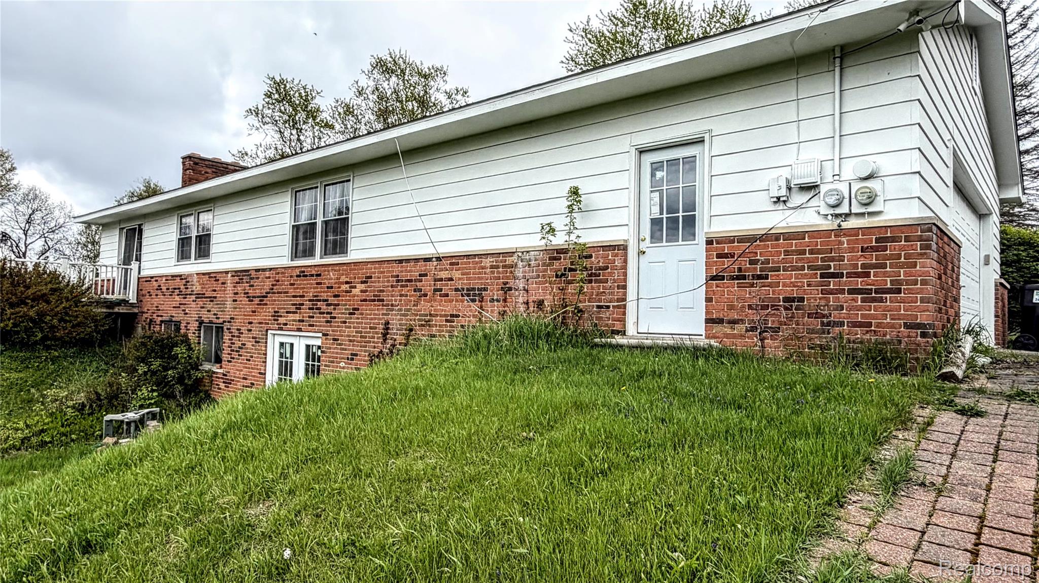 8079 Farley Road Pinckney, MI 48169 - Photo 2 of 43 Back of property featuring brick siding, a yard, and a chimney