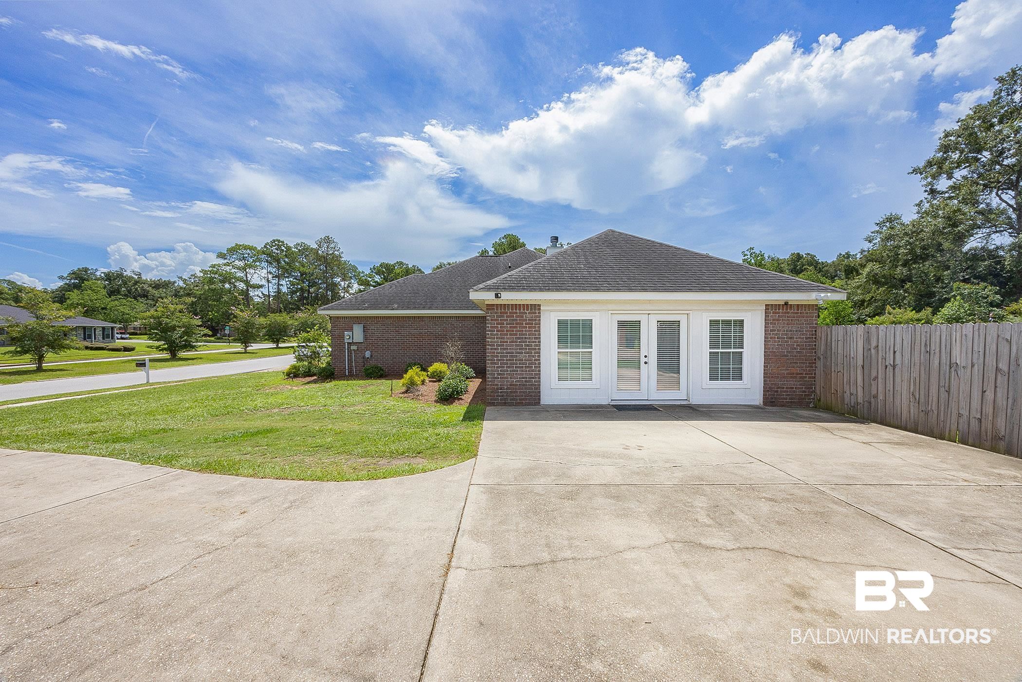 5304 Lansdowne Drive Mobile, AL 36693 - Photo 28 of 28 View of side of property featuring french doors that lead into the bonus room.