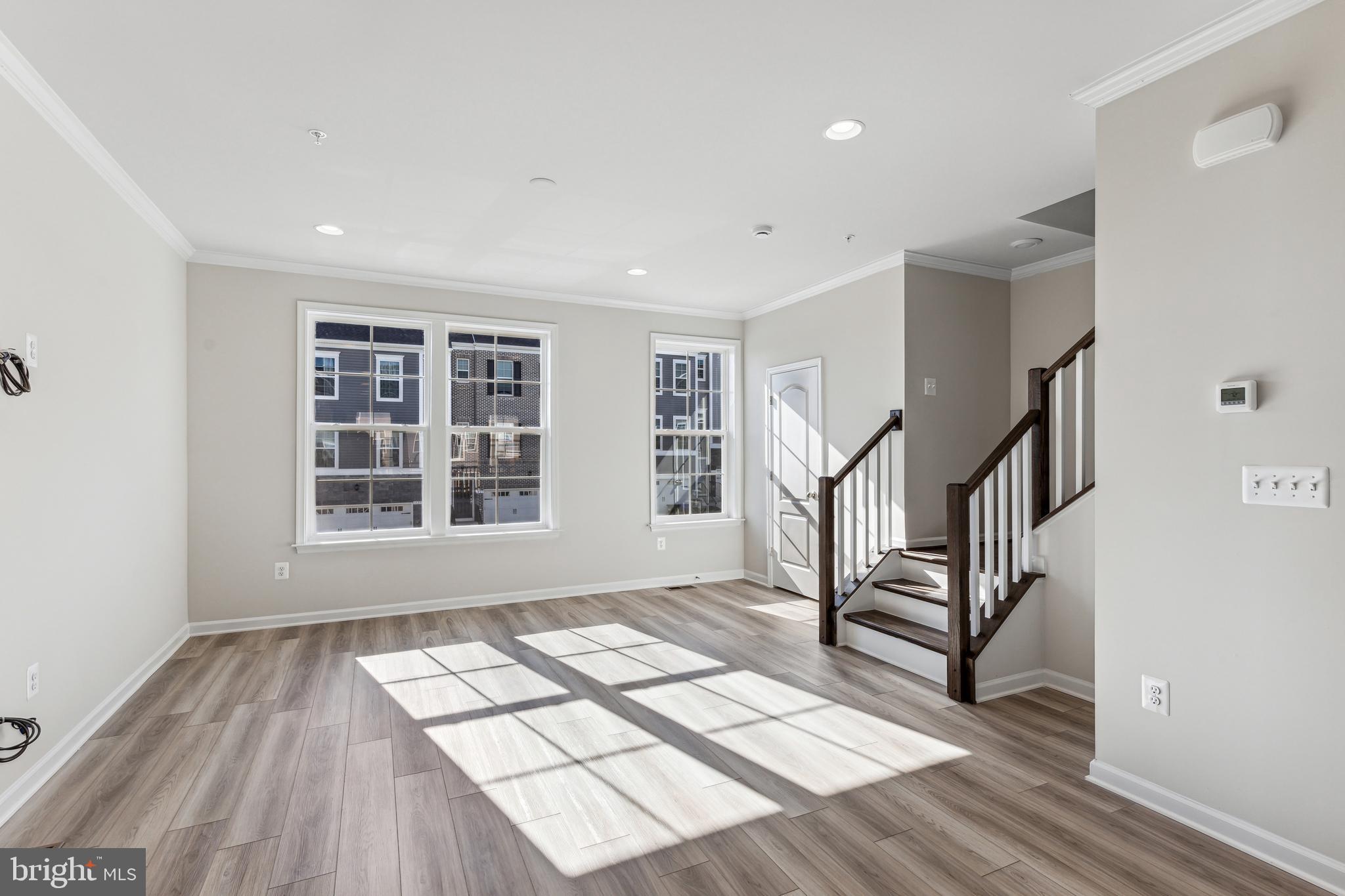 1036 Highpoint Trail Laurel, MD 20707 - Photo 7 of 28 a view of an empty room with wooden floor and a window