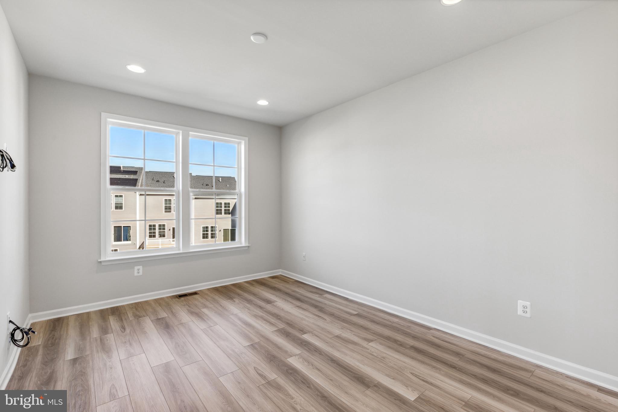 1036 Highpoint Trail Laurel, MD 20707 - Photo 8 of 28 a view of an empty room with wooden floor and a window