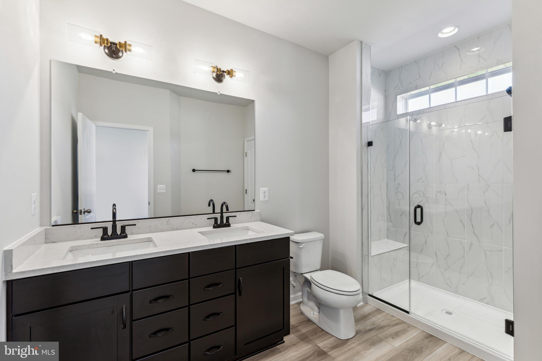 1036 Highpoint Trail Laurel, MD 20707 - Photo 10 of 28 a bathroom with a toilet a sink and mirror