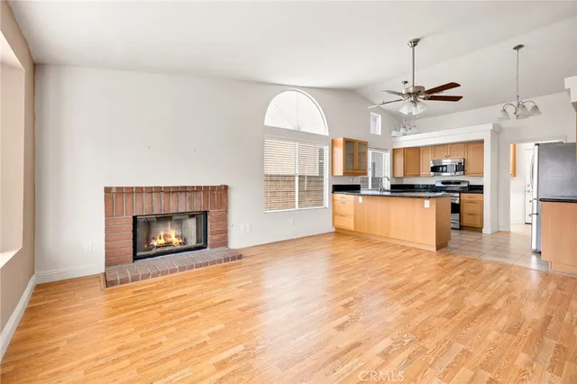 a kitchen with granite countertop a refrigerator stove top oven and sink