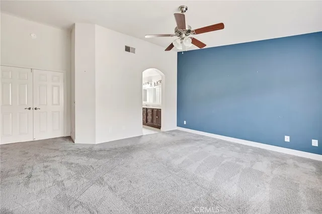 a bathroom with a granite countertop double vanity sink a mirror and a bathtub