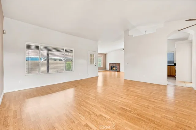 a view of a kitchen with wooden floor and a ceiling fan