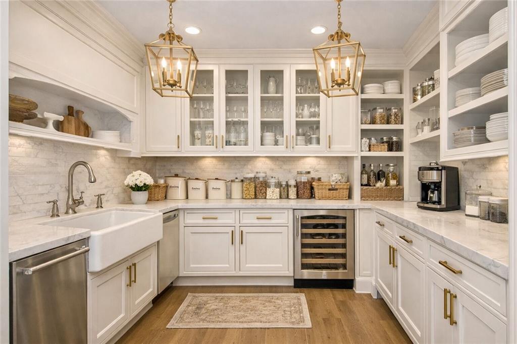 410 East Church Street Monroe, GA 30655 - Photo 13 of 50 a kitchen with stainless steel appliances granite countertop a sink and cabinets
