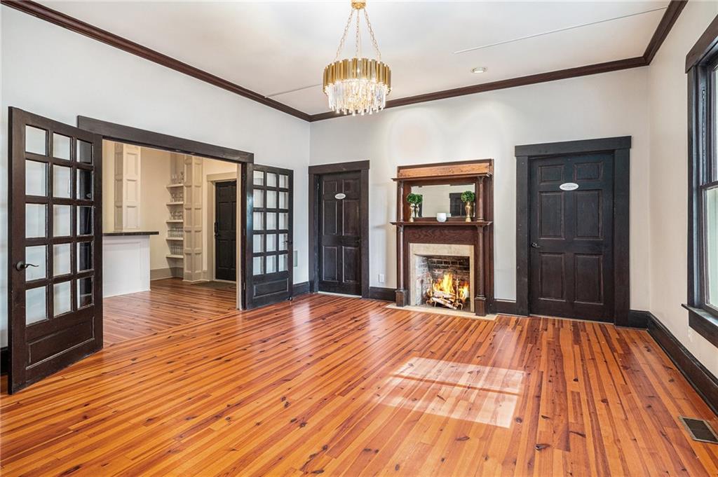 410 East Church Street Monroe, GA 30655 - Photo 14 of 50 a view of an empty room with wooden floor and a window