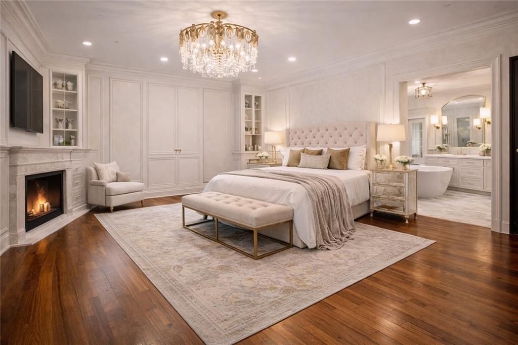 410 East Church Street Monroe, GA 30655 - Photo 15 of 50 a spacious bedroom with a bed and a chandelier