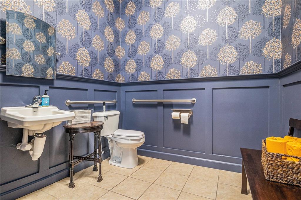 410 East Church Street Monroe, GA 30655 - Photo 16 of 50 a bathroom with a sink a toilet and mirror