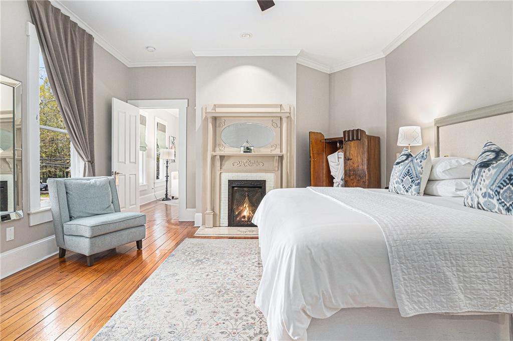 410 East Church Street Monroe, GA 30655 - Photo 22 of 50 a spacious bedroom with a balcony a bed and a couch