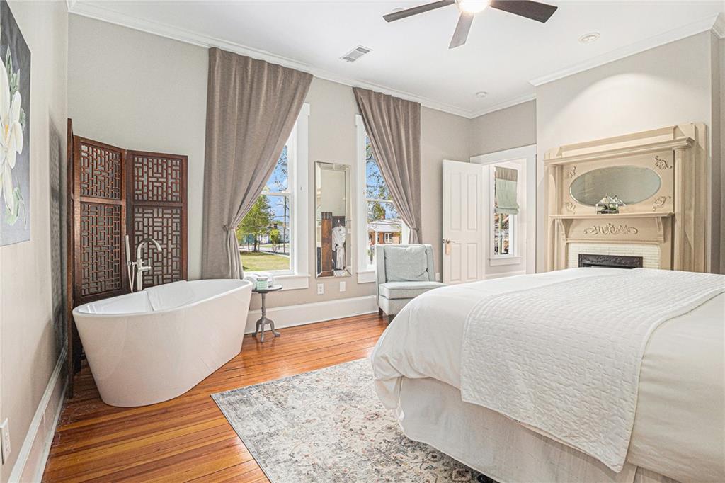 410 East Church Street Monroe, GA 30655 - Photo 23 of 50 a spacious bedroom with a large window and a bed