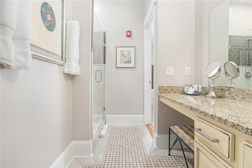 410 East Church Street Monroe, GA 30655 - Photo 24 of 50 a bathroom with a granite countertop sink a mirror and a shower
