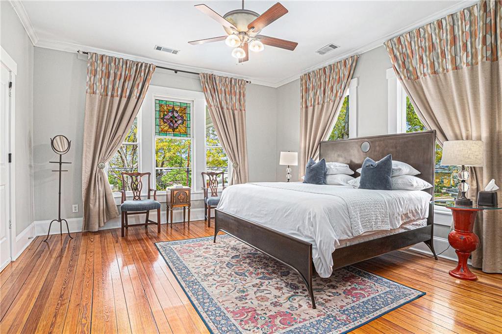 410 East Church Street Monroe, GA 30655 - Photo 26 of 50 a bedroom with a bed a large window and walk in closet