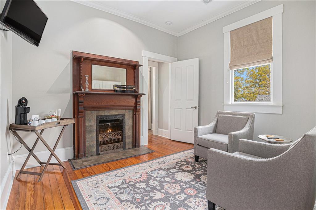 410 East Church Street Monroe, GA 30655 - Photo 27 of 50 a living room with furniture a flat screen tv and a fireplace