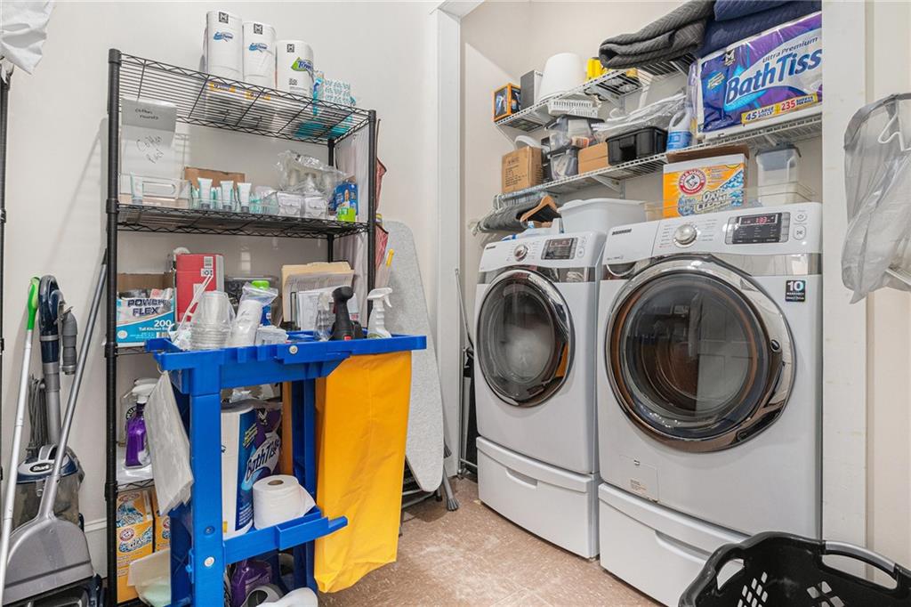 410 East Church Street Monroe, GA 30655 - Photo 33 of 50 a utility room with dryer washer and a view of living room