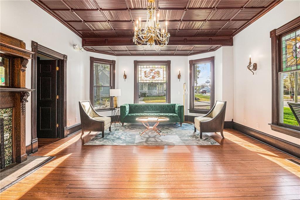 410 East Church Street Monroe, GA 30655 - Photo 4 of 50 a dining room with wooden floor a glass table and chairs