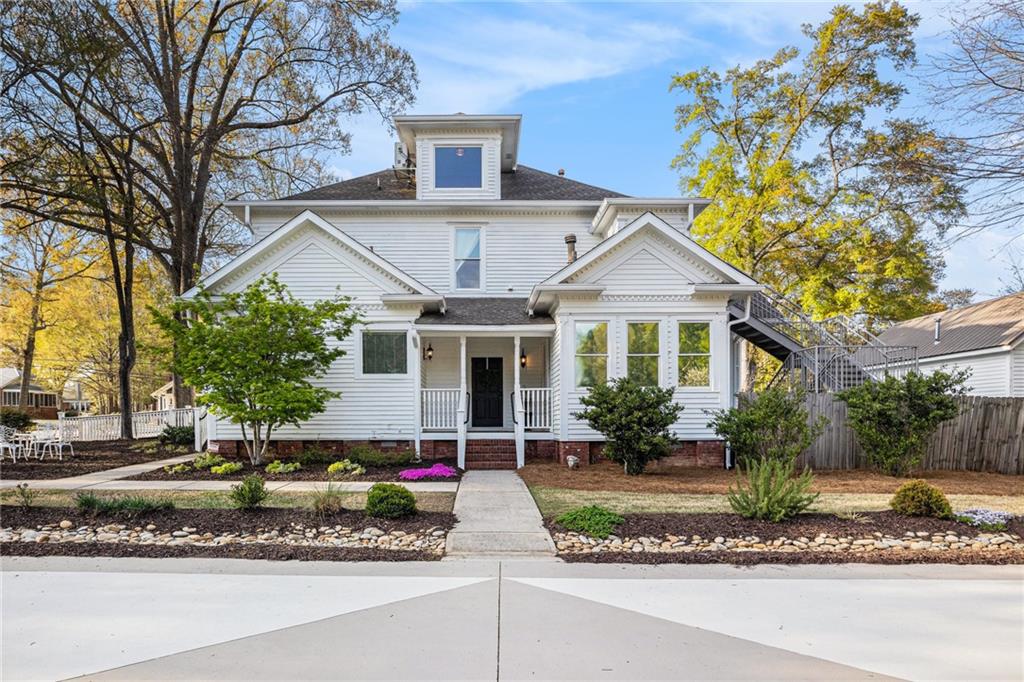 410 East Church Street Monroe, GA 30655 - Photo 44 of 50 a front view of a house with a porch and a yard