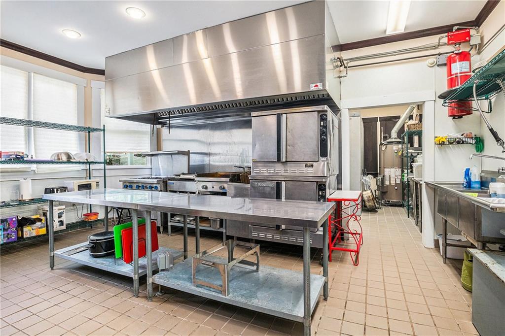 410 East Church Street Monroe, GA 30655 - Photo 10 of 50 a living room with lots of wooden furniture and a large window