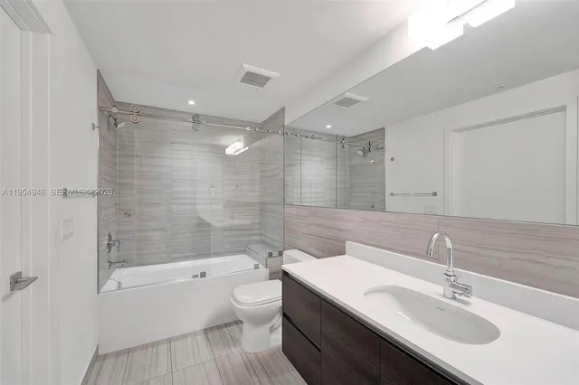 an empty room with windows and entrance