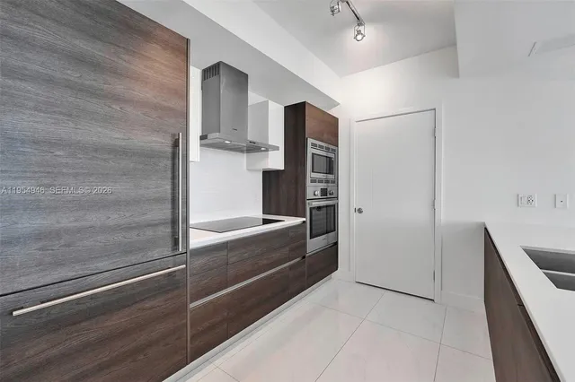 a view of kitchen and a refrigerator