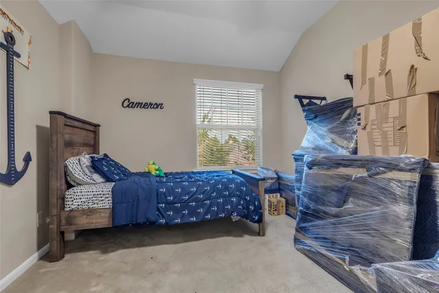 a bedroom with furniture and a window