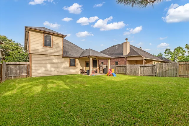 a view of a house with backyard and porch