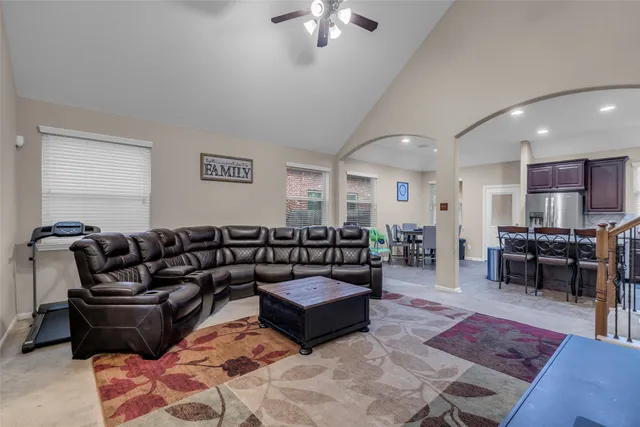 a living room with furniture and a chandelier