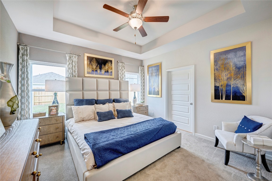 33010 School Hl Road Fulshear, TX 77441 - Photo 12 of 23 a bedroom with a large bed and a chandelier