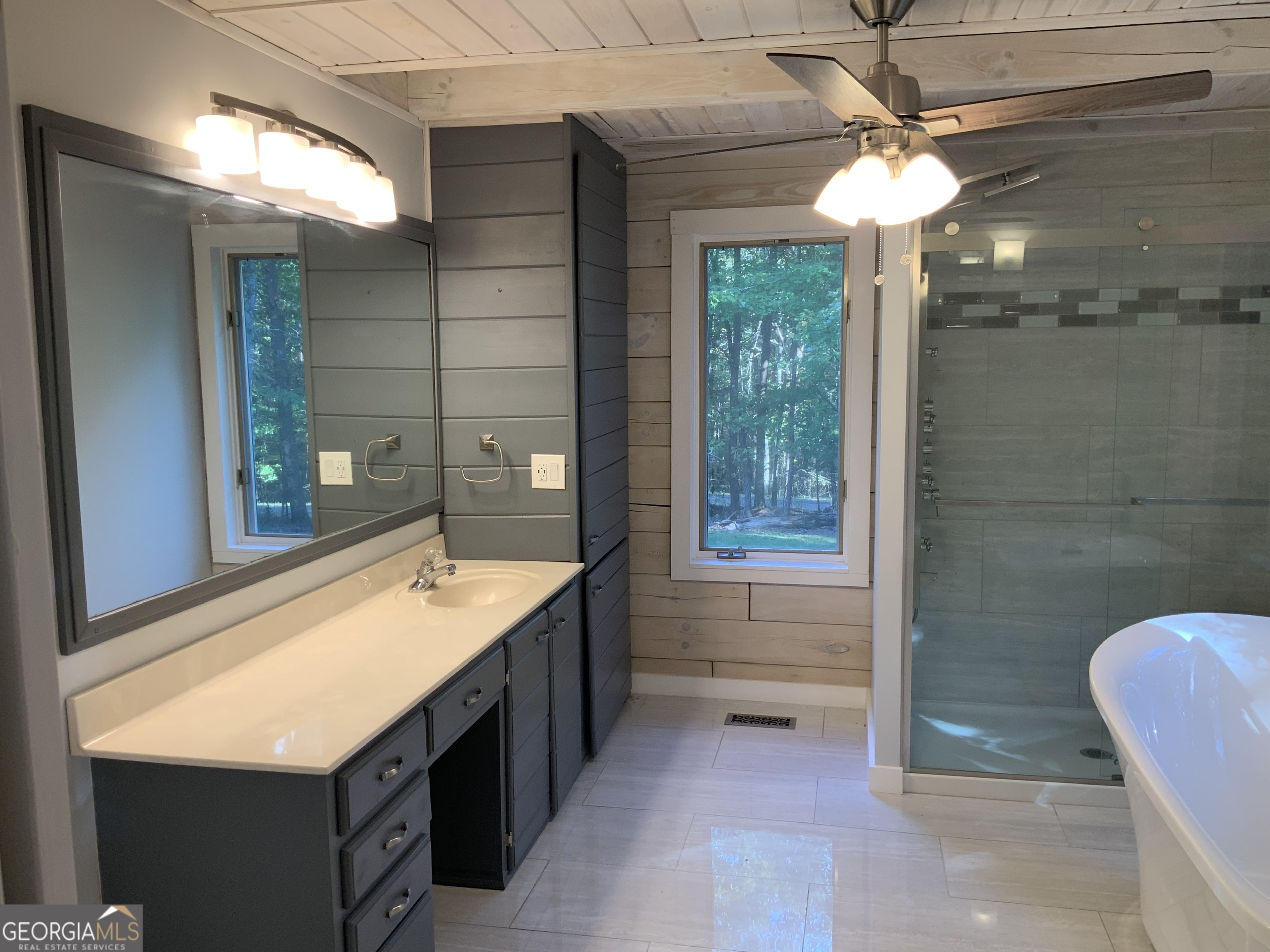 11 Foxfire Road Blairsville, GA 30512 - Photo 30 of 60 a bathroom with a sink a mirror and a shower