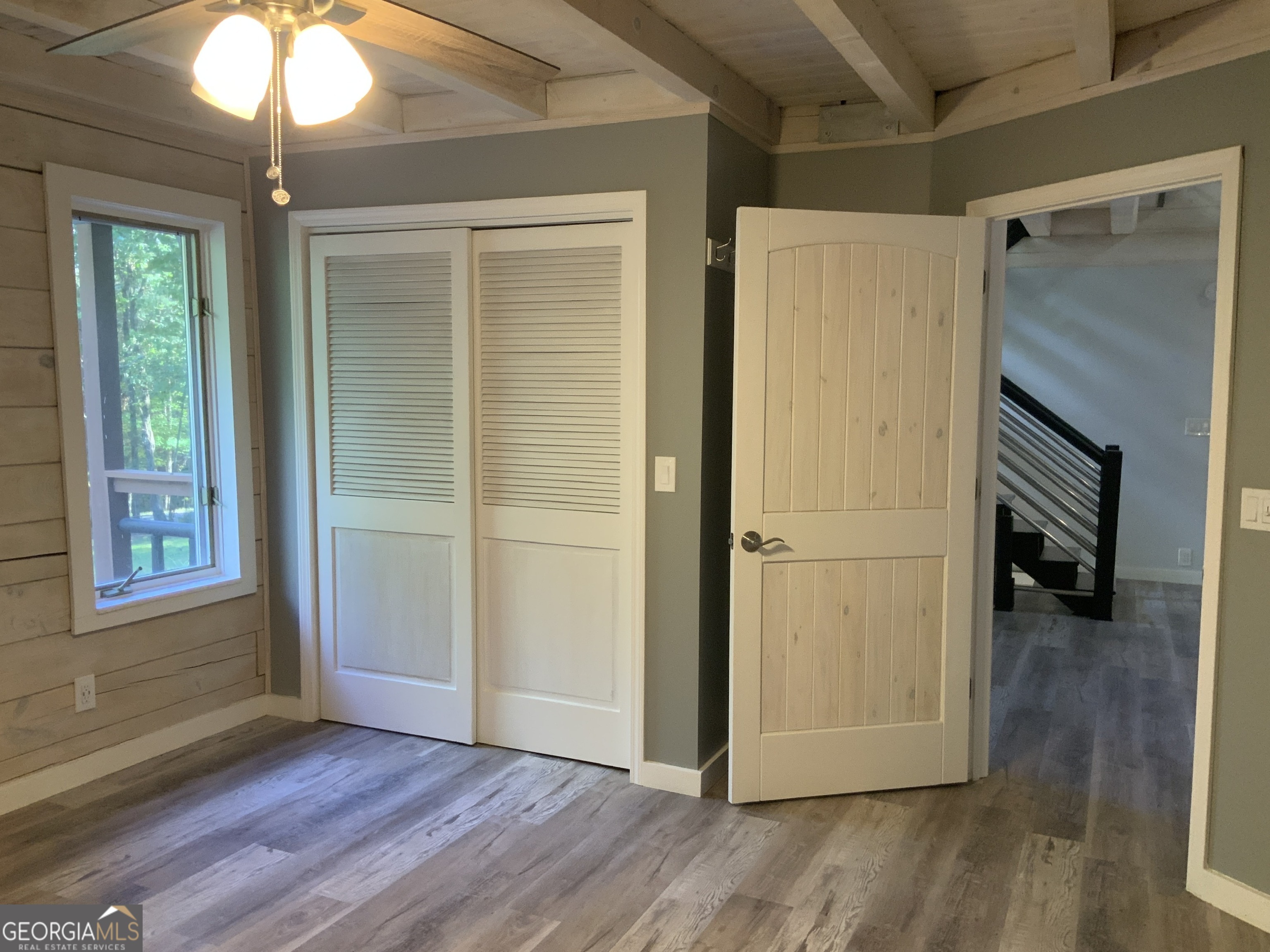11 Foxfire Road Blairsville, GA 30512 - Photo 36 of 60 a view of an empty room with wooden floor and a window