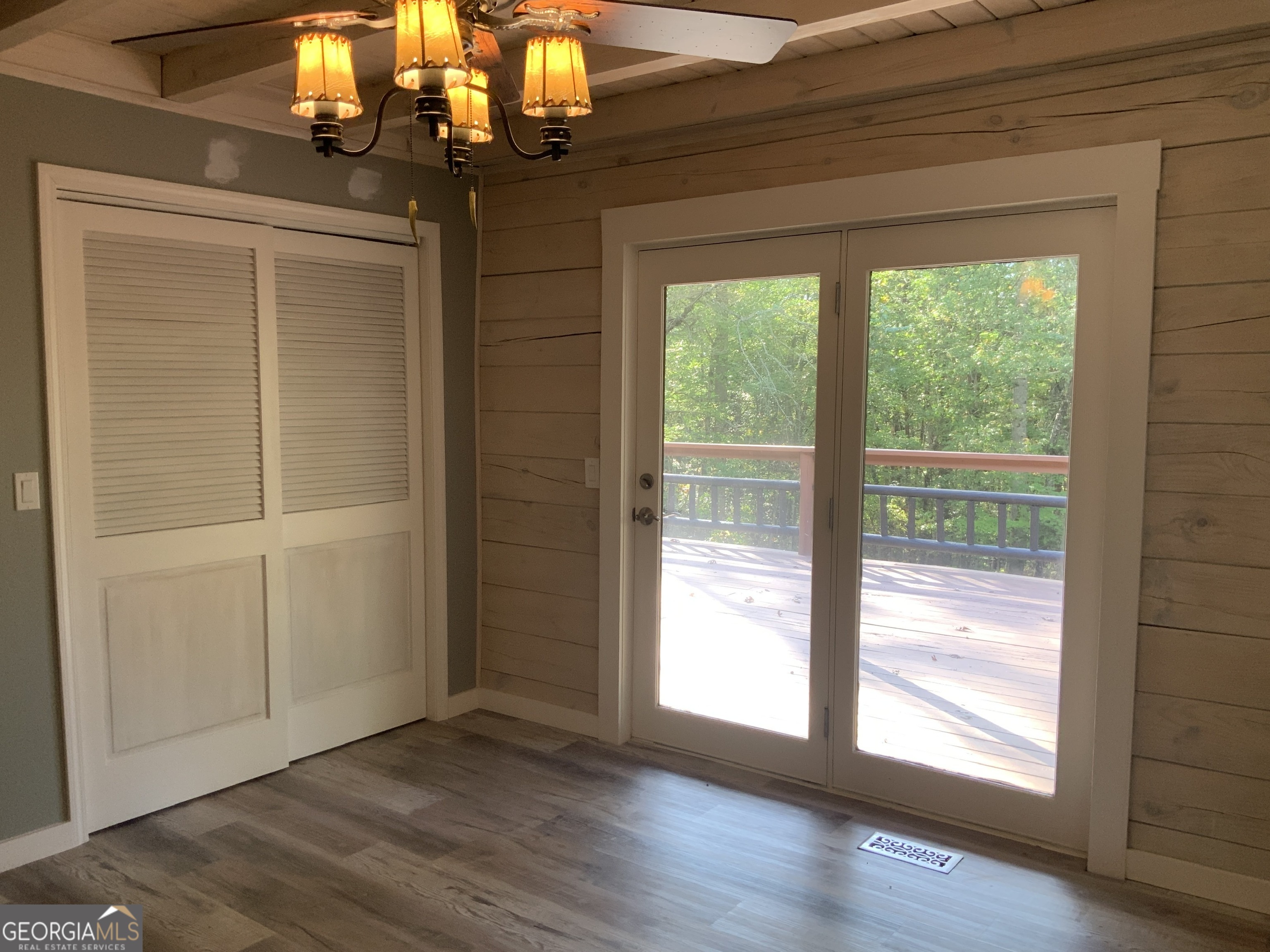 11 Foxfire Road Blairsville, GA 30512 - Photo 39 of 60 a view of an empty room with wooden floor and a window