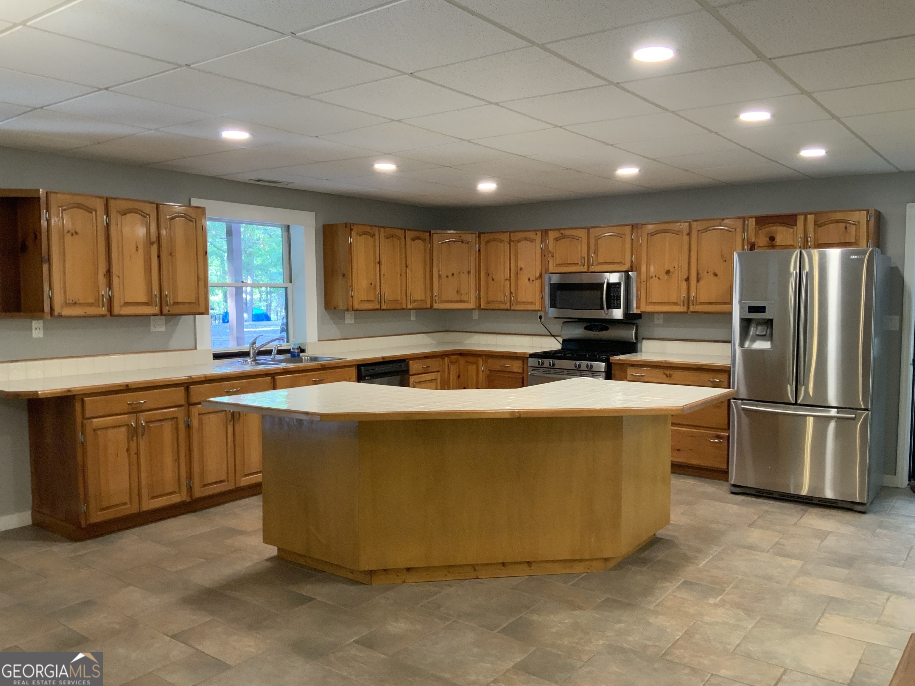 11 Foxfire Road Blairsville, GA 30512 - Photo 53 of 60 a kitchen with stainless steel appliances granite countertop a refrigerator a sink a stove a microwave and island with wooden cabinets