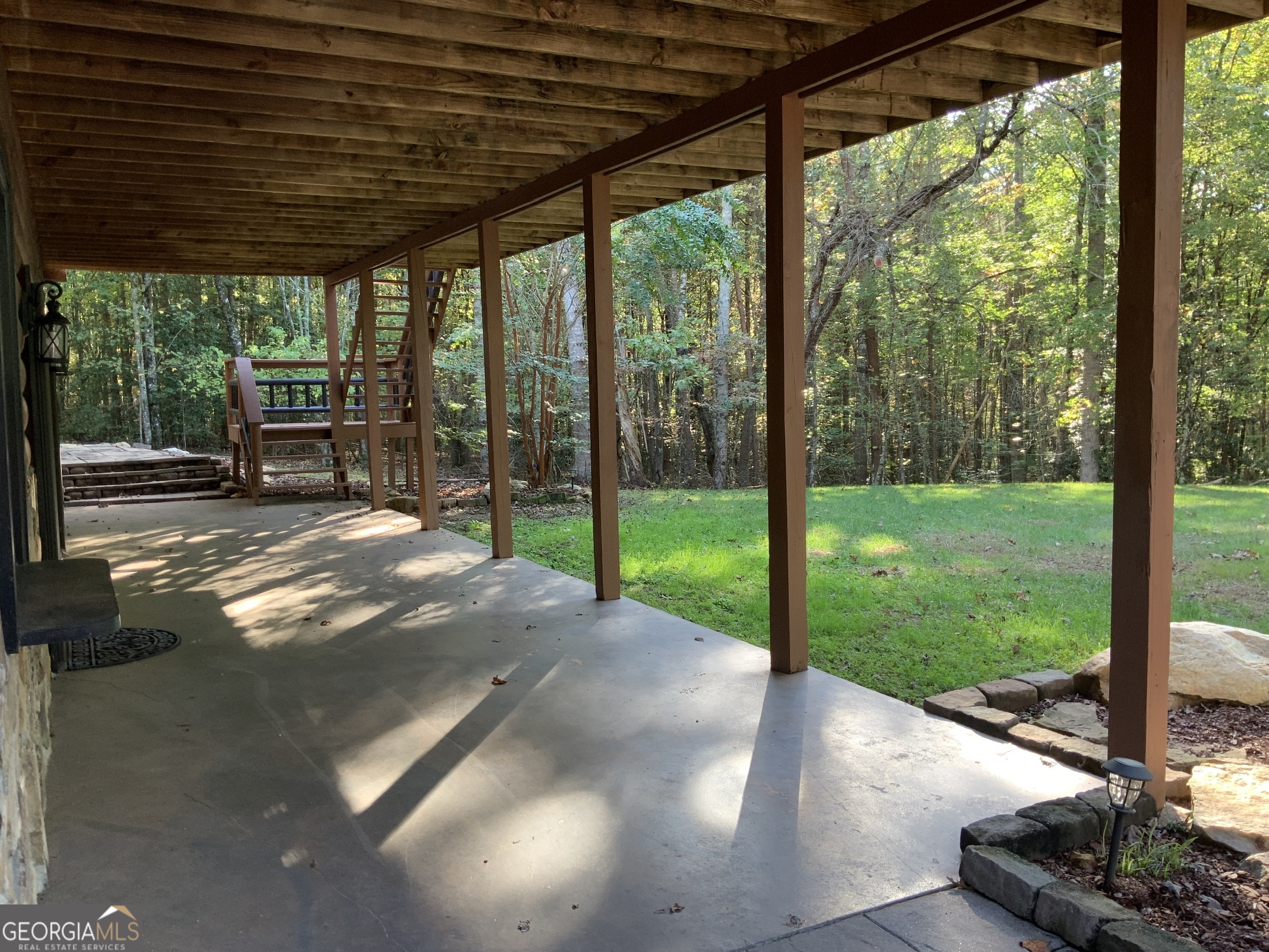 11 Foxfire Road Blairsville, GA 30512 - Photo 58 of 60 a view of a backyard with floor to ceiling windows with wooden floor
