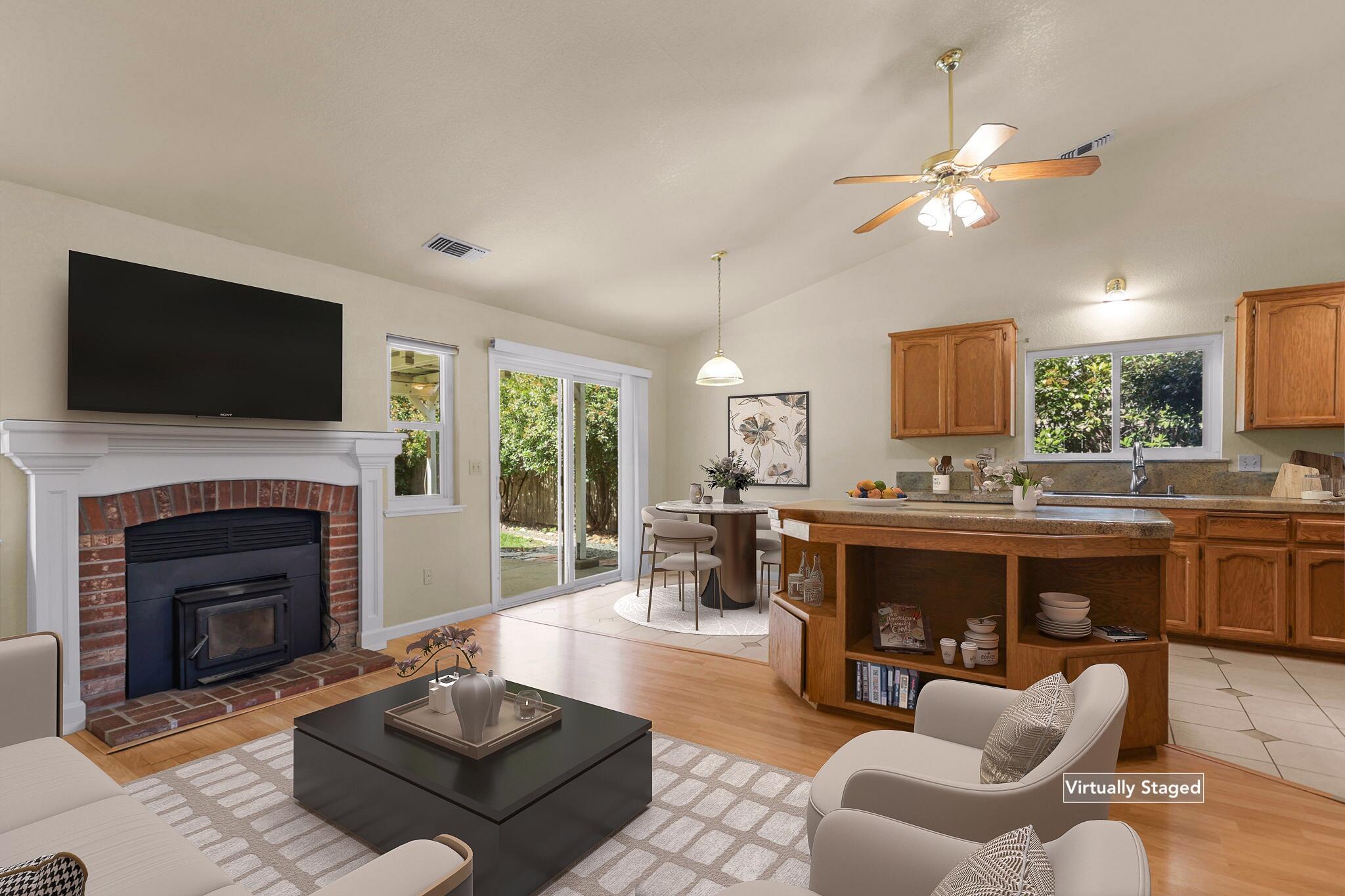 550 Vansicklen Way Redding, CA 96003 - Photo 11 of 52 a living room with furniture a fireplace and a flat screen tv