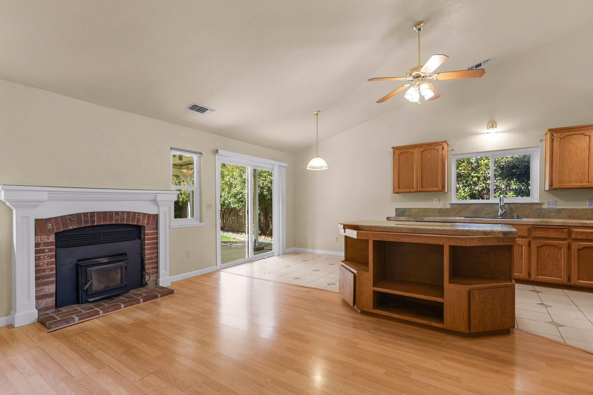 550 Vansicklen Way Redding, CA 96003 - Photo 12 of 52 a kitchen with stainless steel appliances granite countertop a stove top oven a sink and a fireplace