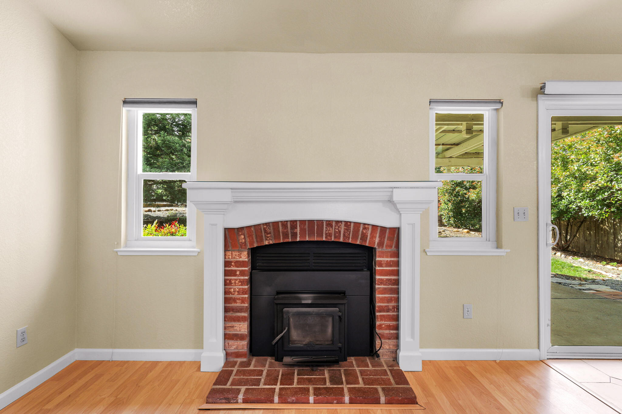 550 Vansicklen Way Redding, CA 96003 - Photo 13 of 52 a living room with a fireplace and windows